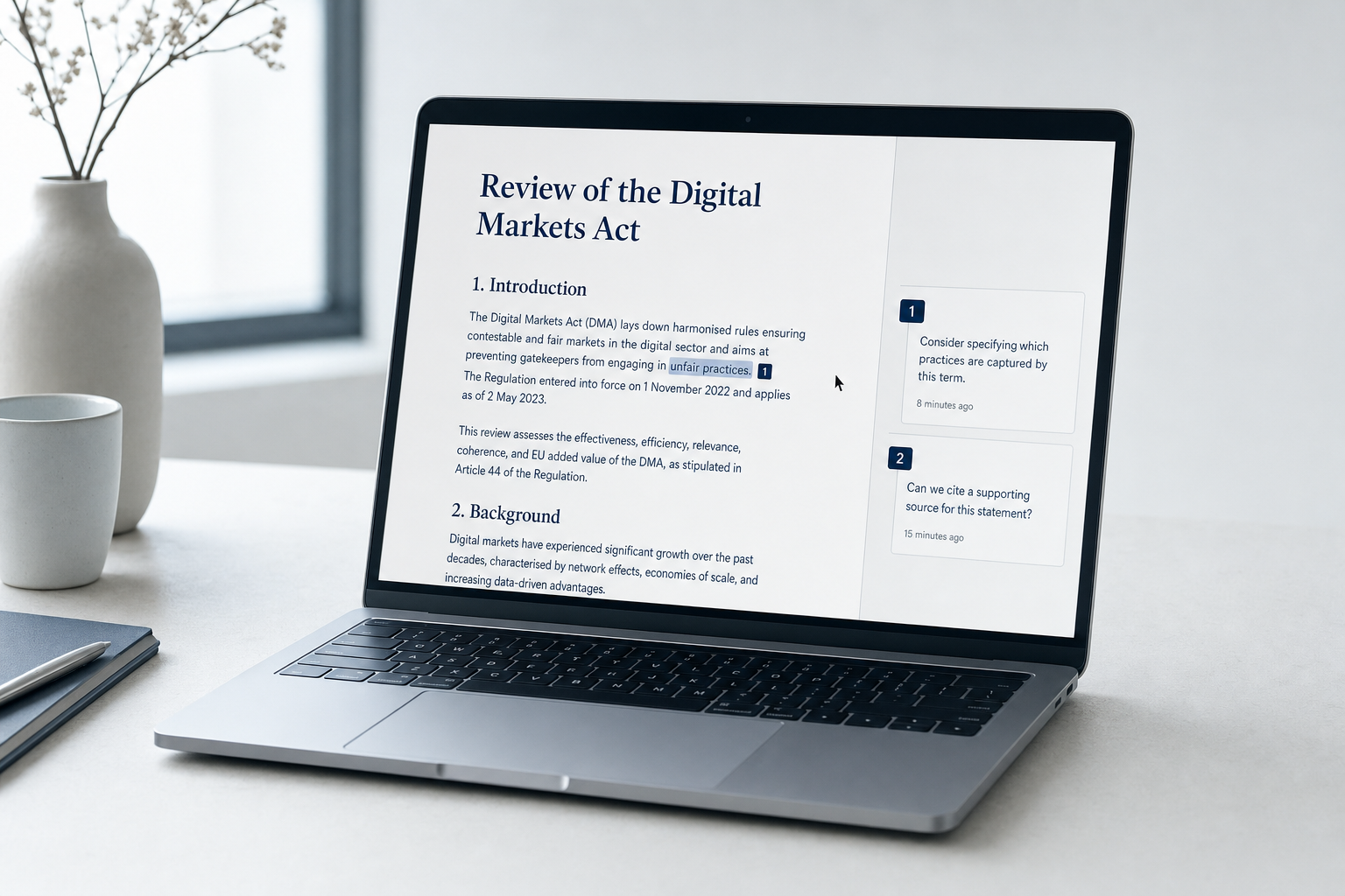 A laptop showing a document mid-review, cursor resting in the margin, soft morning light